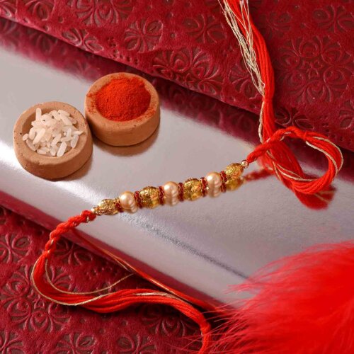 Golden Pearl Rakhi With Dual-Toned Thread