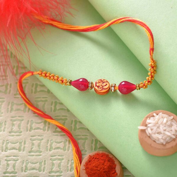 Beautiful Om and Wooden Beads Rakhi Thread with Mouthwatering Kaju Katli.