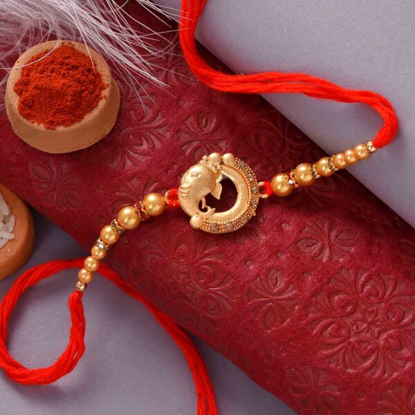 Designer Golden Ganesha and Beads Rakhi With Double Flavoured Cashewnut