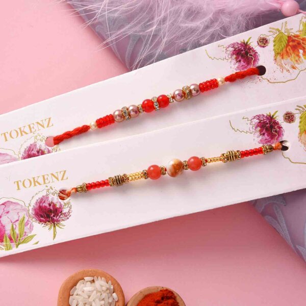 Set of two rakhi with red and orange round beads ,Pista roll and Thali