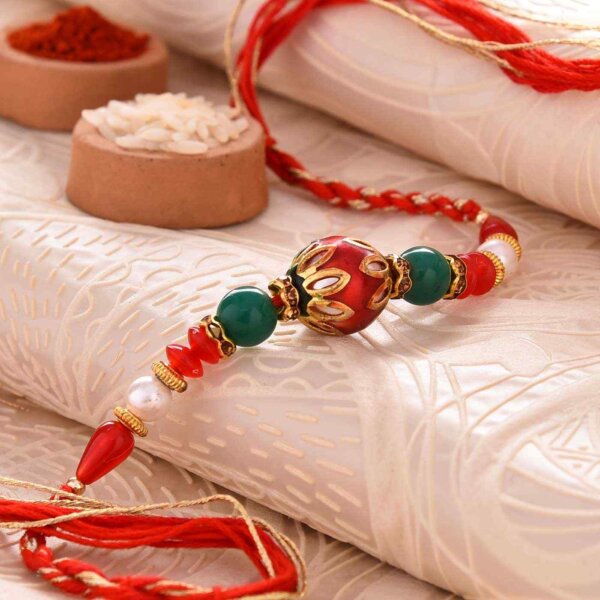 Conventional Red Pearl Rakhi With Dual-Toned Thread