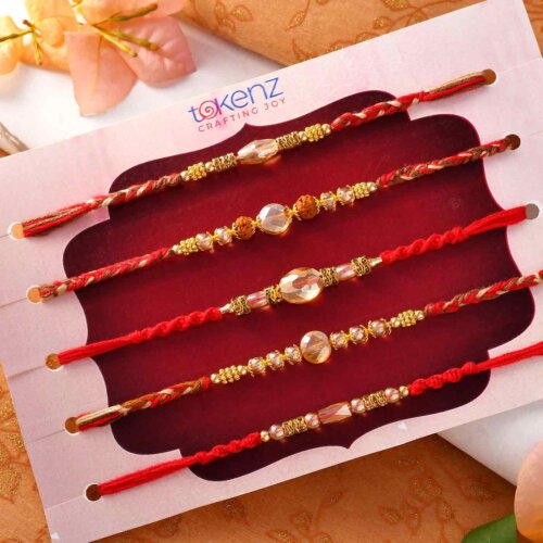 Set Of 5 Golden Pearl Rakhis With Interlaced Thread