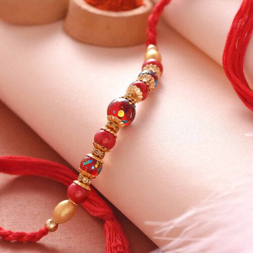 Red Pearl Rakhi With A Silk Thread