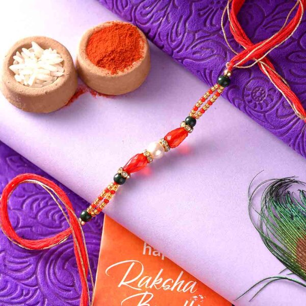 Silver Pearl Rakhi With A Dual-Toned Thread