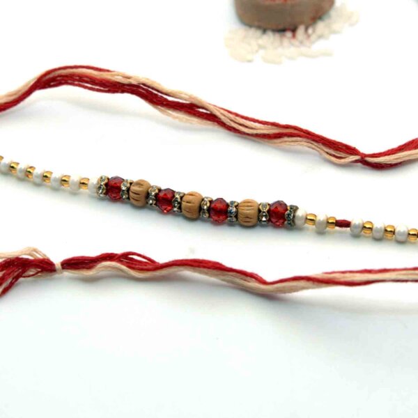 Maroon Beads Rakhi With A Dual-Toned Rakhi