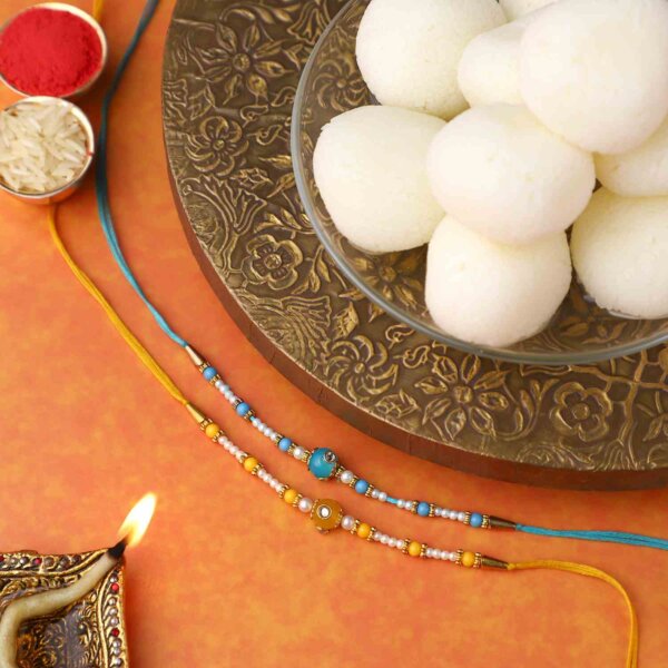 Sneh Vibrant Set Of 2 Pearl Rakhis with 1 Kg Rasgulla Tin