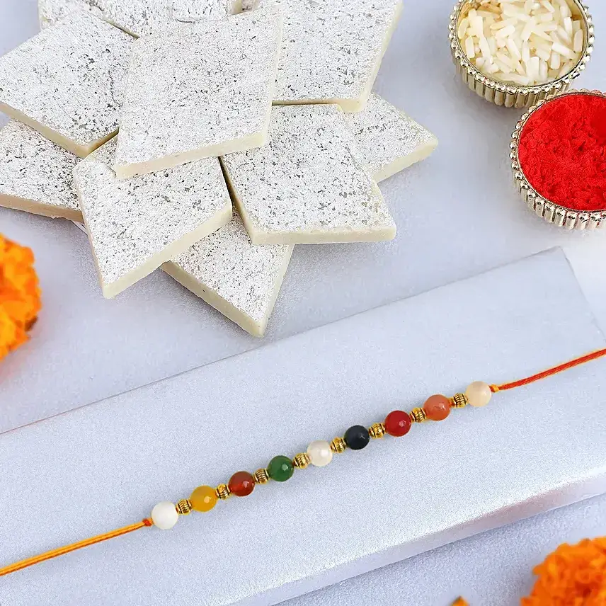 Navratan Sleek Designer Rakhi With Kaju Katli Navratan Sleek Designer Rakhi With Kaju Katli
