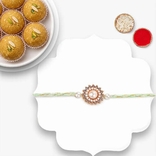 Gold Floral Pearl Rakhi With Besan Laddoo